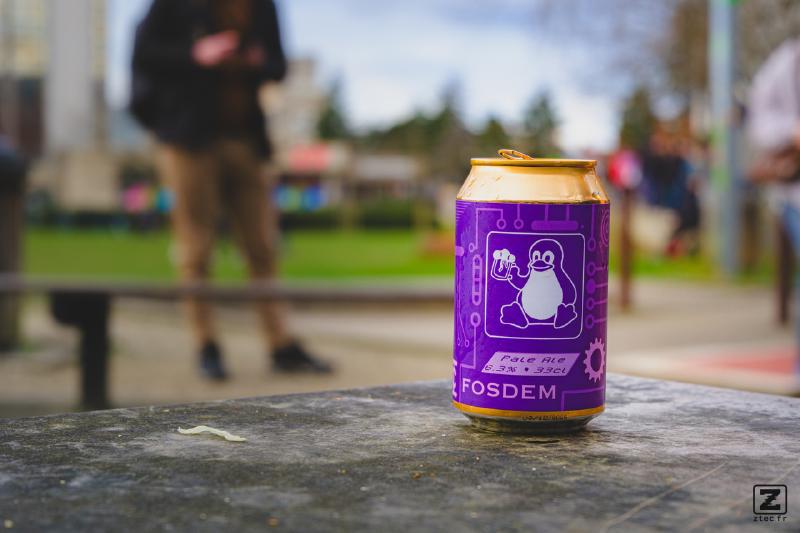 A can of FOSDEM beer brew. Purple with a Tux on it.