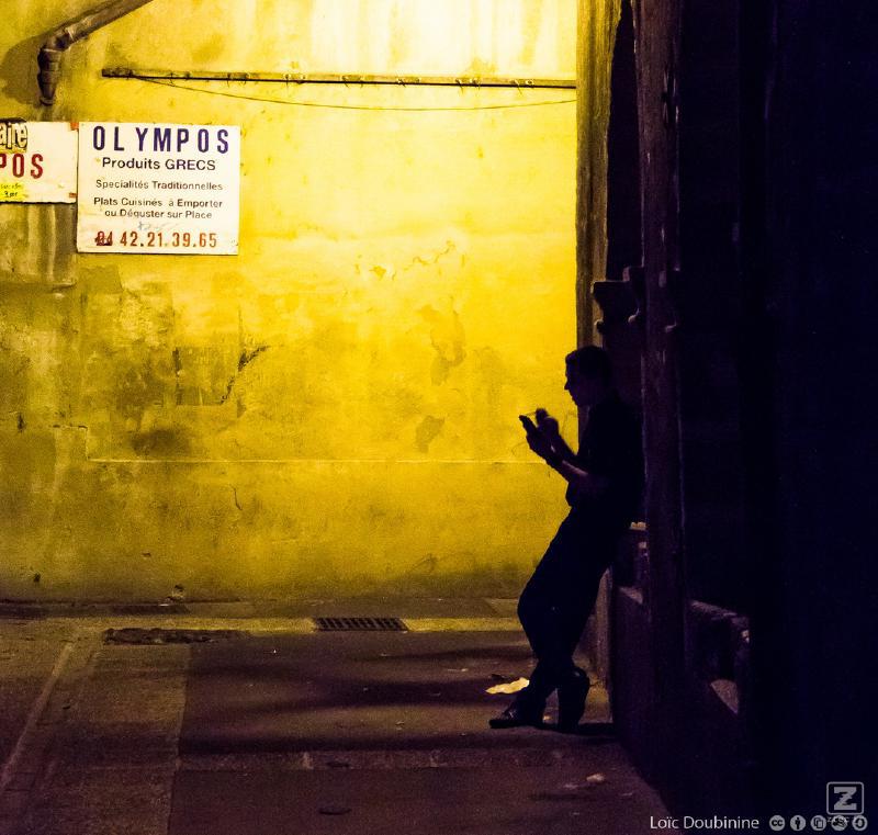 A worker is taking a break with his phone and a cigatrette in the dark of the light !
https://www.flickr.com/photos/ztec/9517446550/