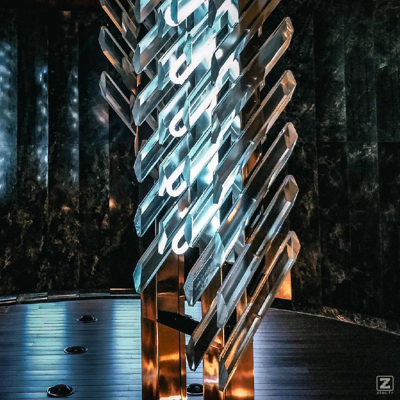 A set of modern squared crystals handing from the ceiling with light shining though. Taken at Národní divadlo
https://www.flickr.com/photos/ztec/53162881407/