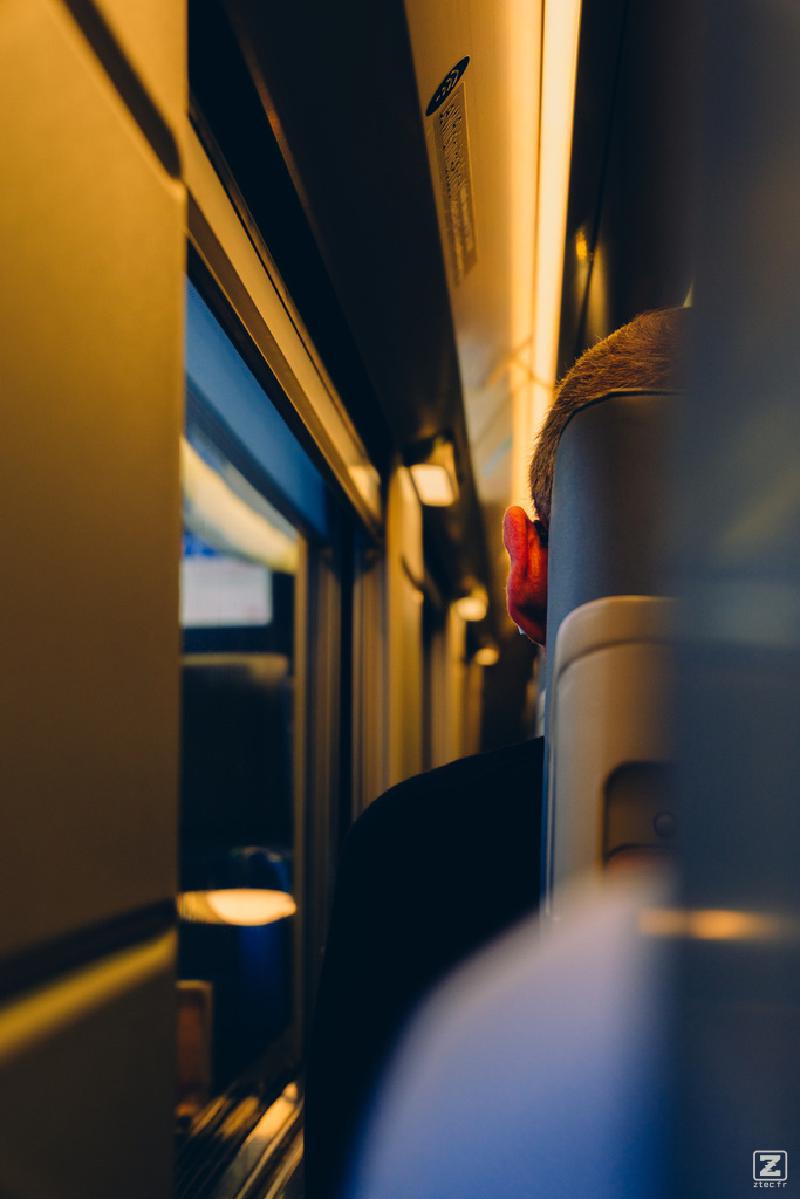 Closeup of someone ear siting on the train