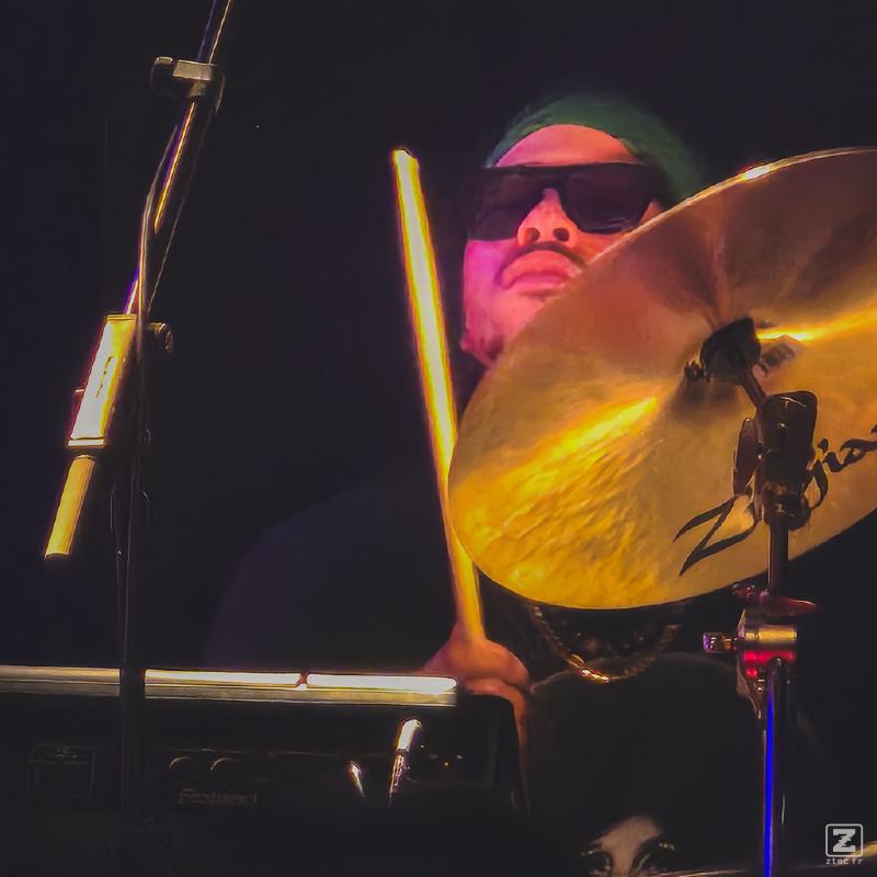 David Frazier playing drums with sun glasses