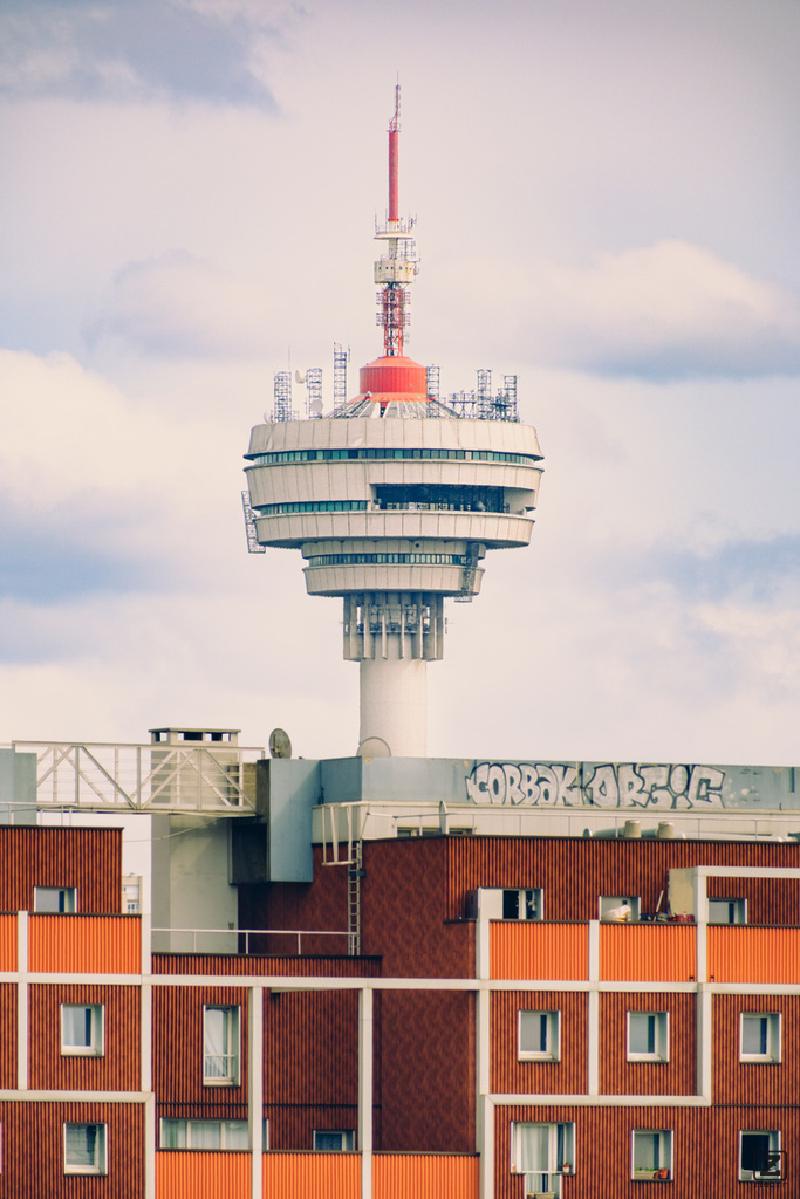 A tv tower sprouting from a red brick building