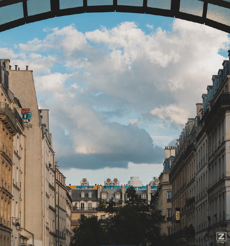Typical parisians building with some elements from the Beaubourg museum over the roof of the center building. 