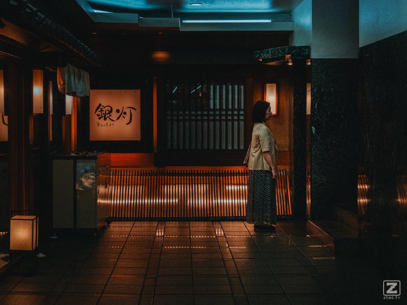A woman is waiting for the elevator to come in a Street of Sendai
