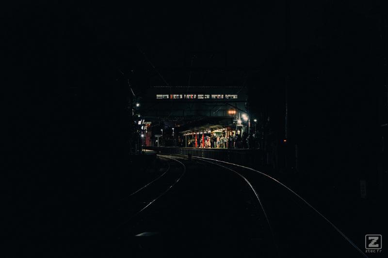 A train station in the middle is visible in the dark