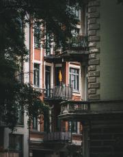 A flat balcony in Hamburg with a closed yellow sun-shade