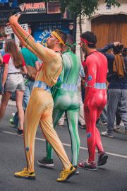 3 guy in full body costume of power-ranger like colors. One taking a selfie.
