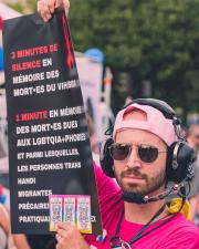 A man with a sign about 3-4 minute of silence for the death of AIDS
