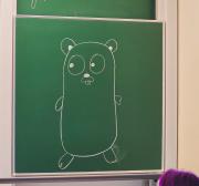 The go dev room traditional gopher drawn on the board