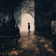 A child walking in a museum. There is black wires everywhere as part of the exposition. The child is visible as a silhouette 