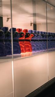 A line of Maneki-neko with black leather mask.