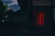 A house taken in the dark. A red glow come from the inside