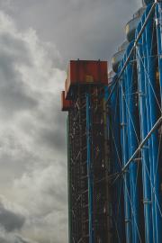 Side of Beaubourg building with two red box on top of industrial building. They look like elevators, but are not.