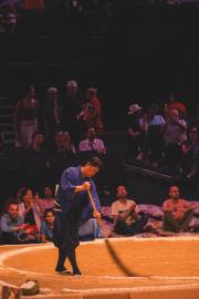 Cleaning guy that is browning the sumo arena after a fight