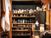 Back-end of a ceramic shop with shelf full of cup and ceramic pot. 
https://www.flickr.com/photos/ztec/53159188912/