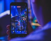 A phone recording the concert. We can see Jean-Loup playing Guitar on the screen