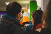 Someone with a VLC cone on their head queuing for coffee. 