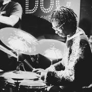 Koleby Royston playing drums at Theo Croker concert