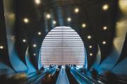 Multiple mechanical stairs going up to an erg shape ceiling 