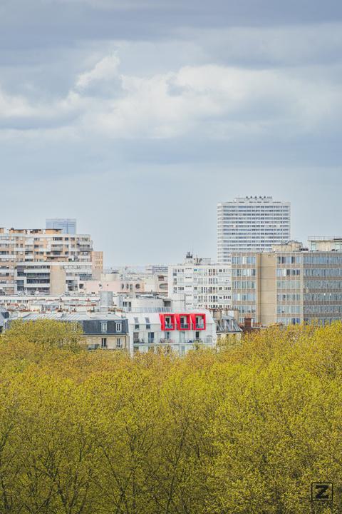 Paris roof top buildings in the nature with red window/balcony