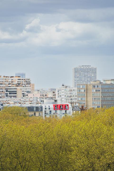 Paris roof top buildings in the nature with red window/balcony