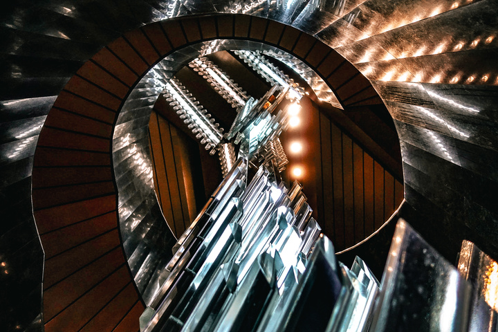 A circular stairway with a model squared crystals handing in the middle. Taken at Národní divadlo
https://www.flickr.com/photos/ztec/53163959003/
