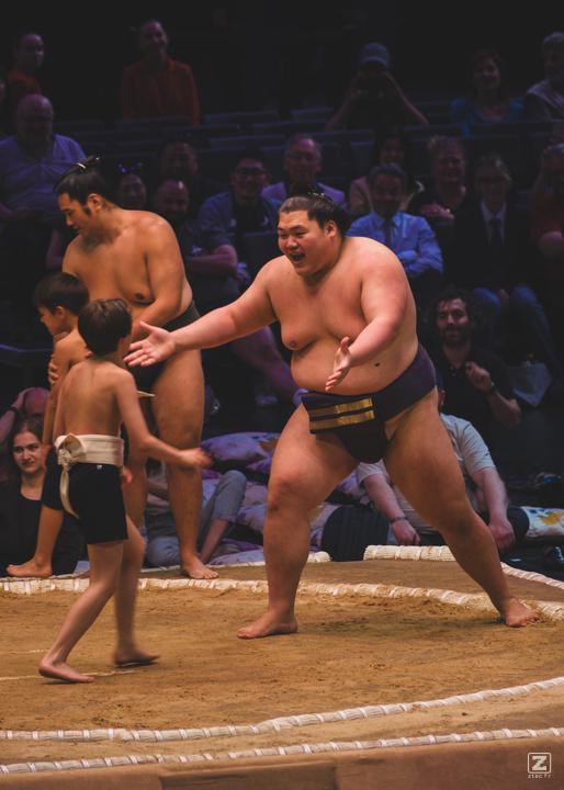 A sumo open arms to welcome a sumo child