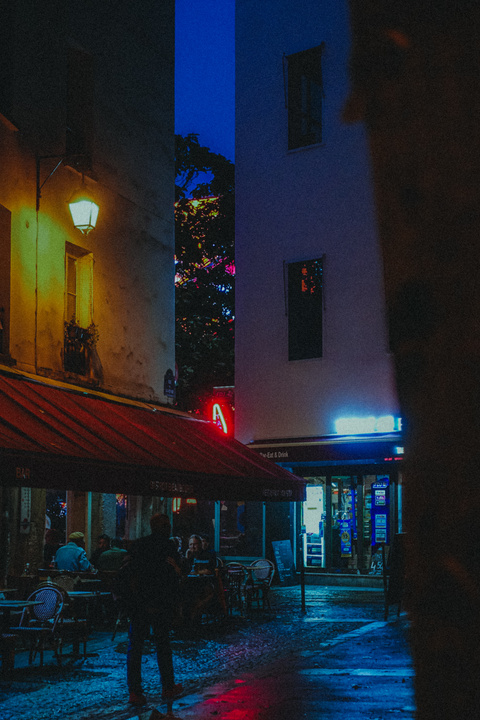 Parisian street with a man walks by a typical bar.
https://www.flickr.com/photos/ztec/53885194516/