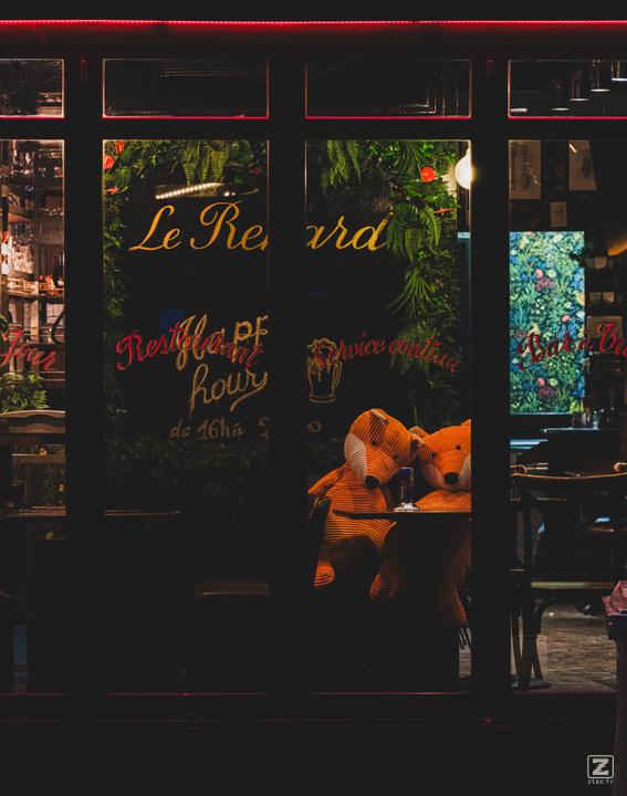 Two foxes in a parisian restaurant.