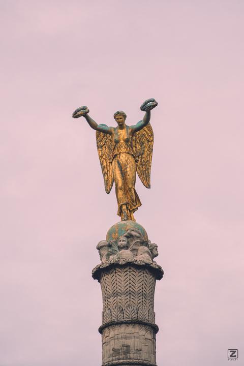 An angel on top of a column/monument in Paris