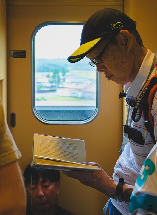 A man read a book in a train