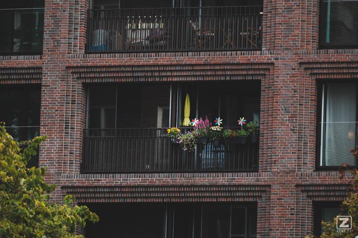 A flat balcony in Hamburg with a closed yellow sun-shade