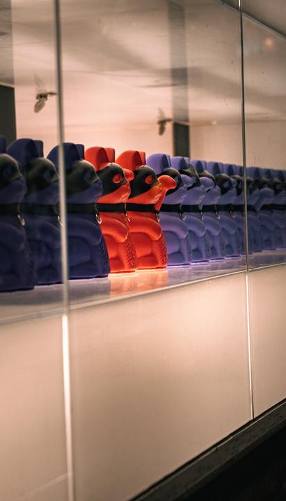 A line of Maneki-neko with black leather mask.