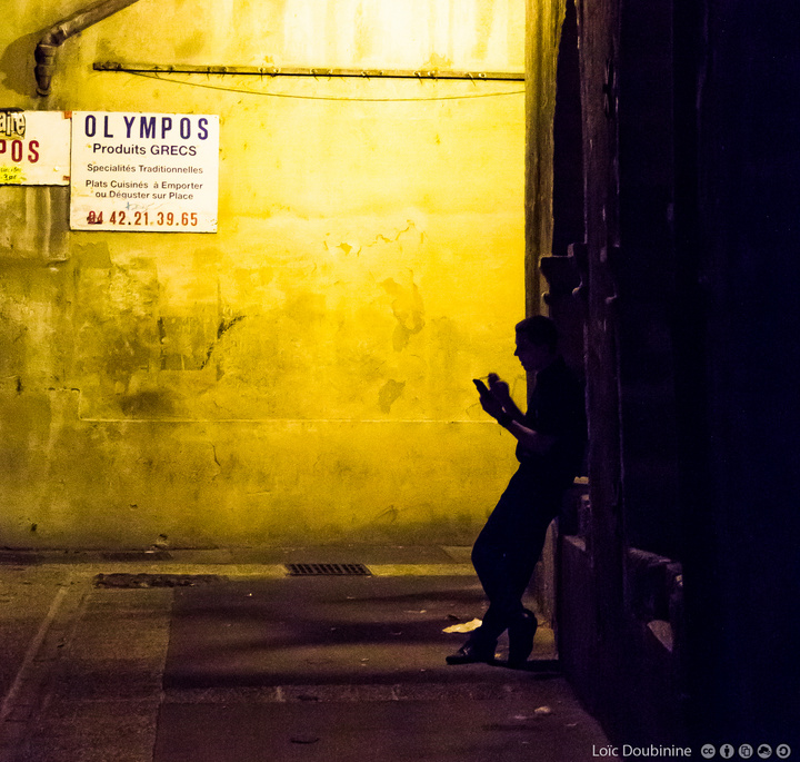 A worker is taking a break with his phone and a cigatrette in the dark of the light !
https://www.flickr.com/photos/ztec/9517446550/