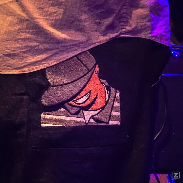 A closeup on the pant's pocket of Theo Croker with a drawing of his double bass friend Eric Wheeler