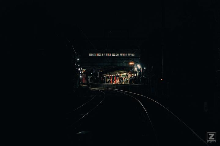 A train station in the middle is visible in the dark