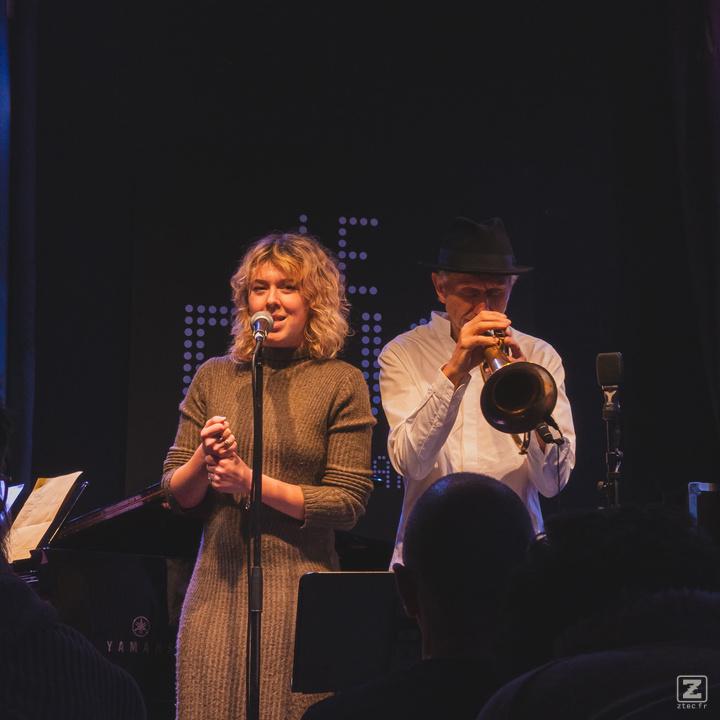 A signer with Erik Truffaz playing trumpet in the back. (name of the woman unknown, any information is welcome) 