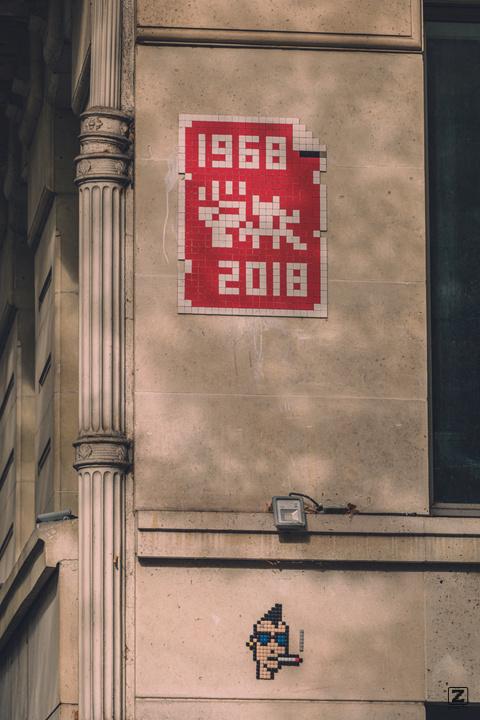 1968 - 2018 fight with a space invader. Mosaic mural. A punk, also in mosaic, is on the bottom.
