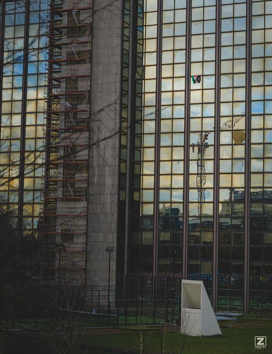 A Palestinian flag hanging of a window on a small sky scraper in from of the ULB Brussel. 