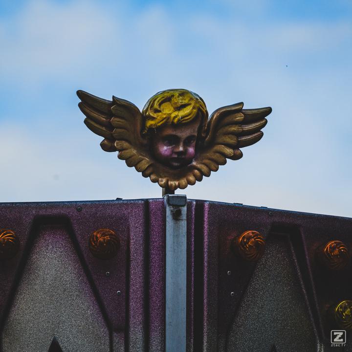 A little ange on top of an attraction ride.