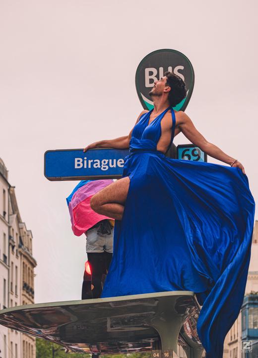A person on top of a bus stop with a blue dress