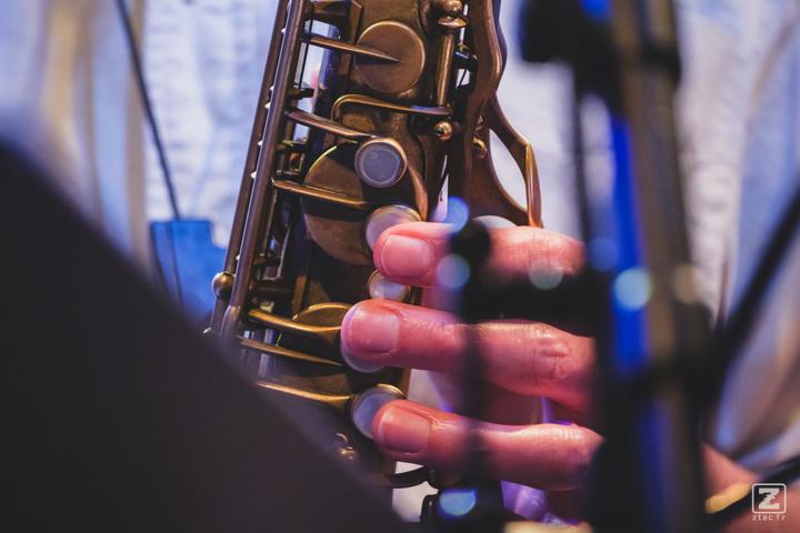 Saxophone closeup with finger playing it  