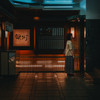 A woman is waiting for the elevator to come in a Street of Sendai