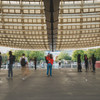 Two persons hugging under the Châtelet canopée. People around them are blurry. 