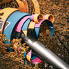 A child playing field structure that look like a colored monster with a metal tube that go out from it's mouth.