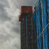 Side of Beaubourg building with two red box on top of industrial building. They look like elevators, but are not.