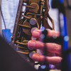 Saxophone closeup with finger playing it  