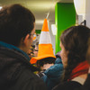 Someone with a VLC cone on their head queuing for coffee. 