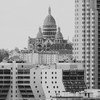 Sacré-coeur in the back (in the center of the frame), and tall modern building surrounding it in the "front" 