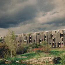 Wood building in a park. The picture in in 3 layer. First ground with the park. Second, the building with it's facade in wood. Then the sky, a bit dramatic. 
https://www.flickr.com/photos/ztec/53412369353/